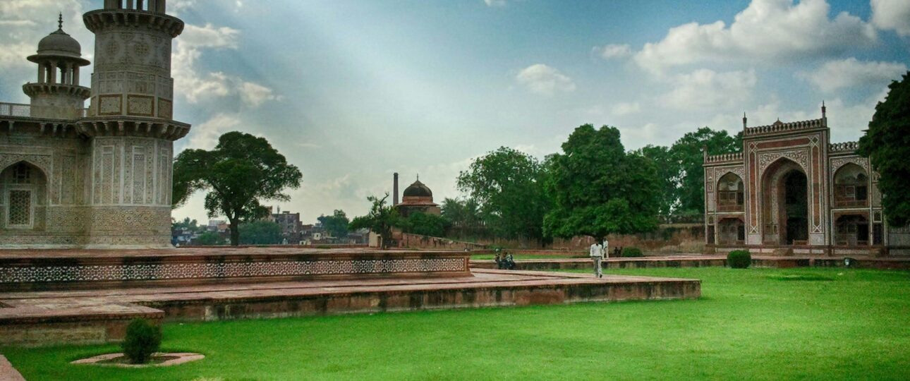 Explore the Fascinating Cultural Hues of Incredible India View of the Itimad-ud-Daulah Tomb surrounded by lush gardens and blue sky in Agra, India.