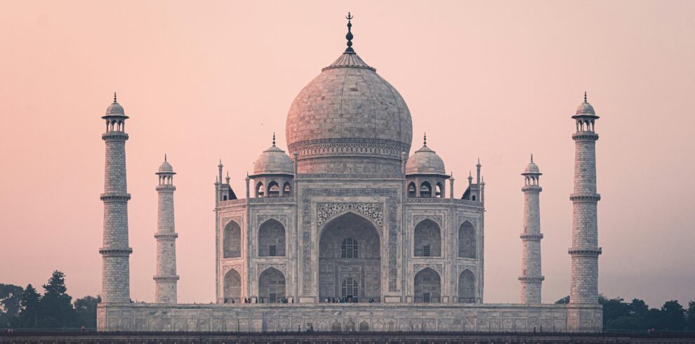 Beautiful view of the Taj Mahal at sunrise, showcasing its stunning architecture and historical significance.